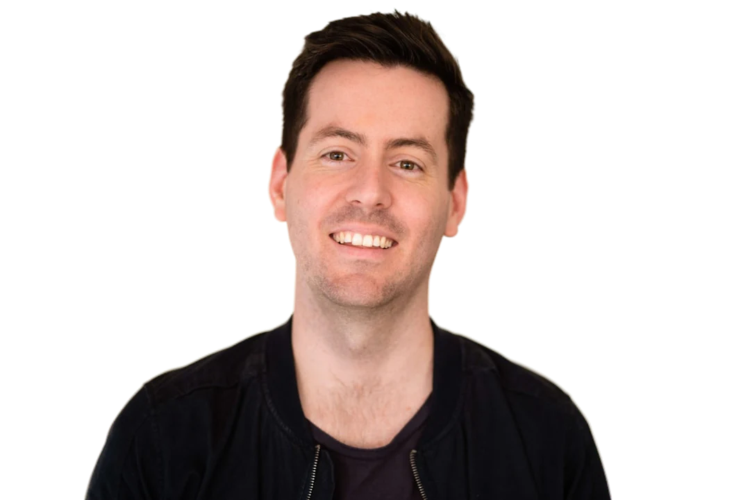 Studio headshot with the background removed, hair edges intact