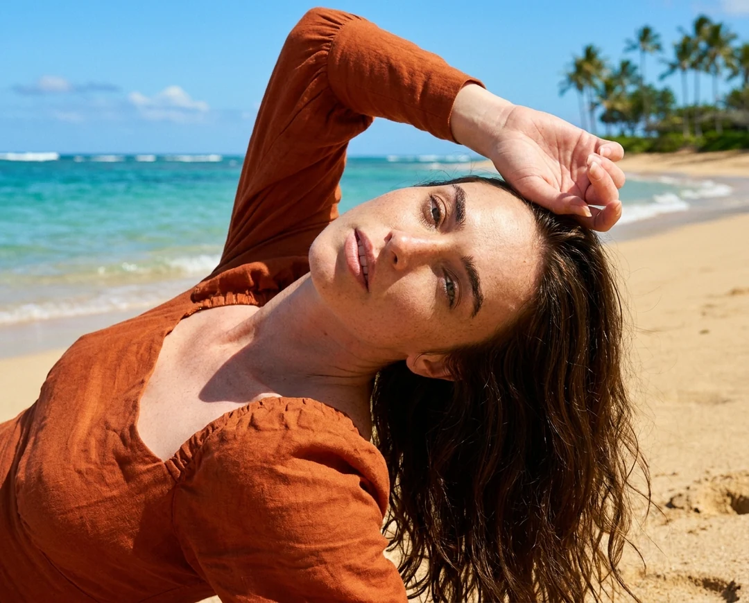 A woman lying on a sunny tropical beach in an orange linen top, a portrait made with the AI photo editor