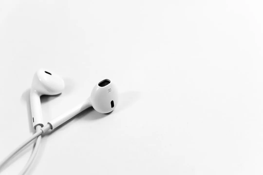 White earbuds on a plain white tabletop