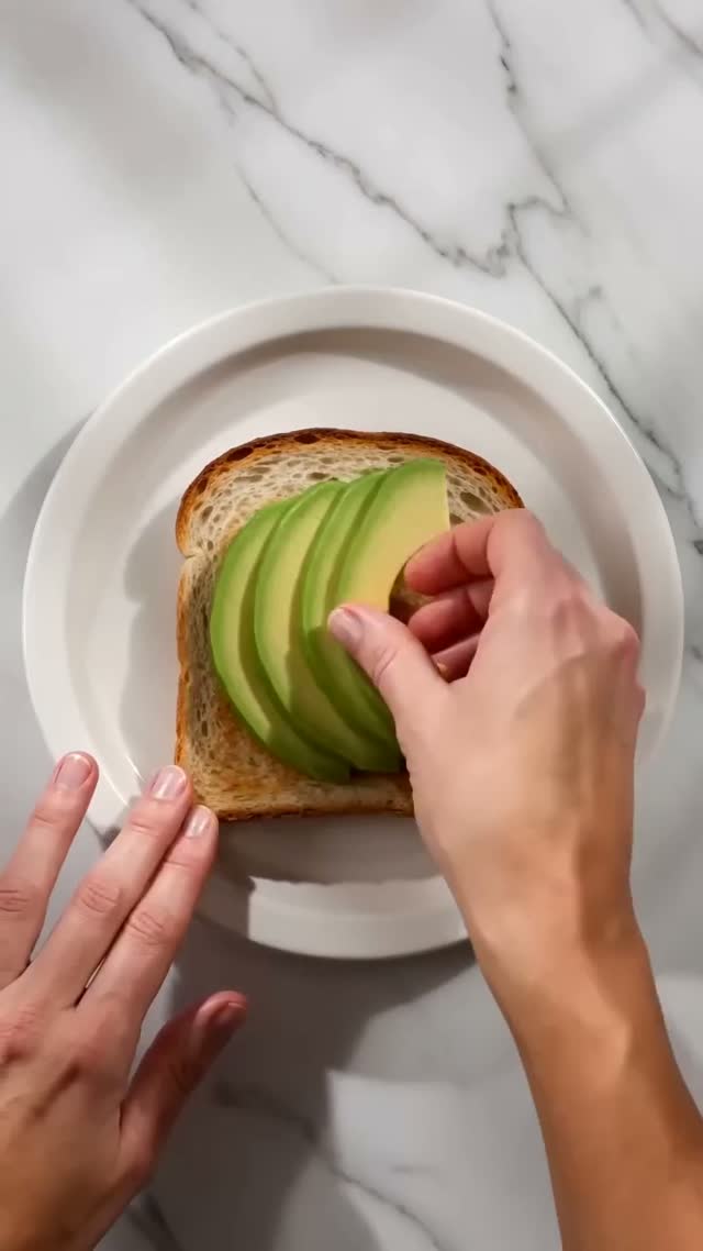 Avocado Toast Is Seasoned on a Marble Plate