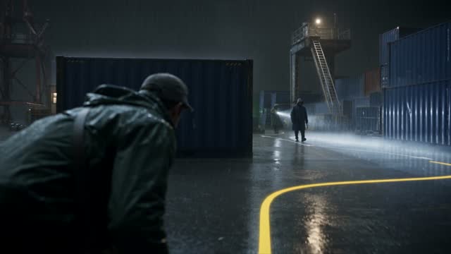 Man Follows a Glowing Route Through a Rainy Warehouse
