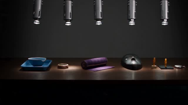 White Gloves Arrange Six Small Material Objects